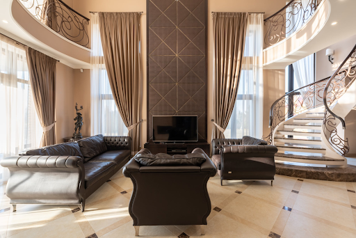 Leather furniture in beautiful living room with spiral staircase