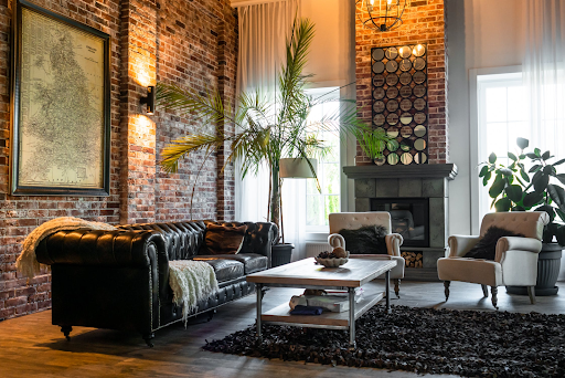 Leather sofaf in living room with high ceiling and brick walls