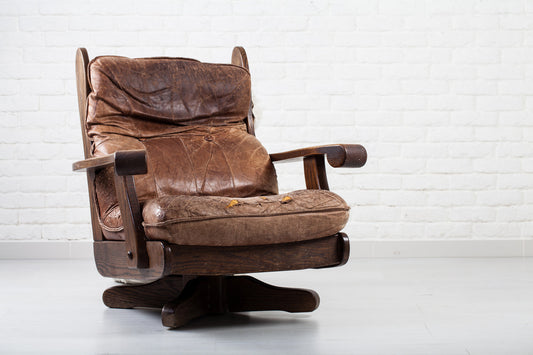 Cracked and dried leather swivel rocker chair